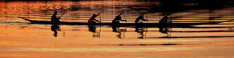 Rowing Team practicing in water at sunset